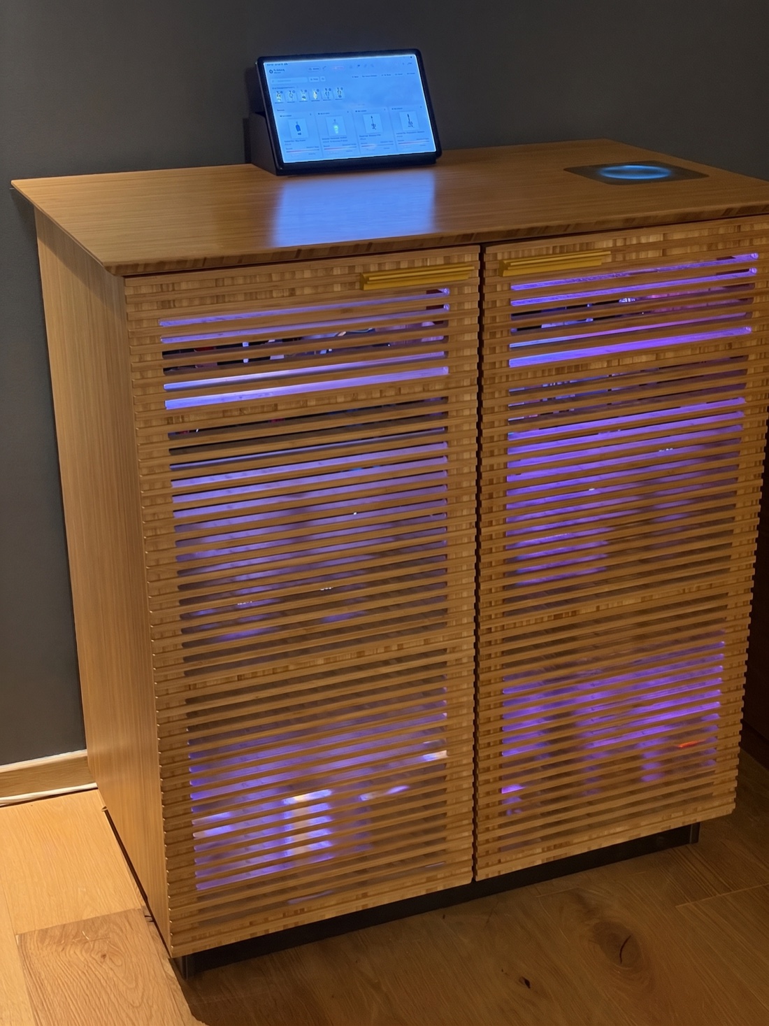 The SmartBarIQ cabinet in natural bamboo, LEDs glowing through the slatted doors